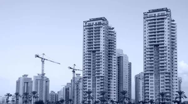 High-rise residential buildings under construction. The site wit