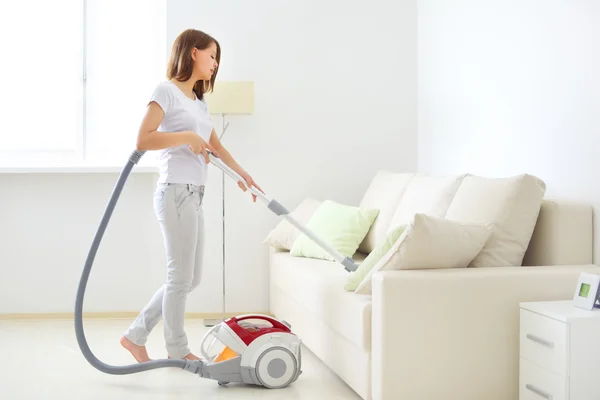 Attractive girl with vacuum cleaner