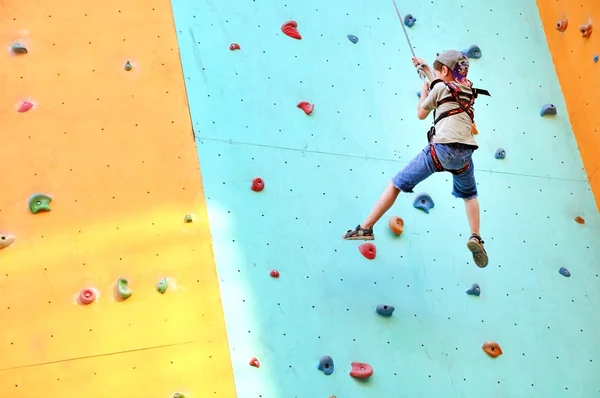 Child climbing up the wall