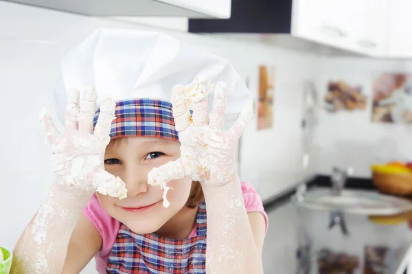 Little girl cooking in kitchen