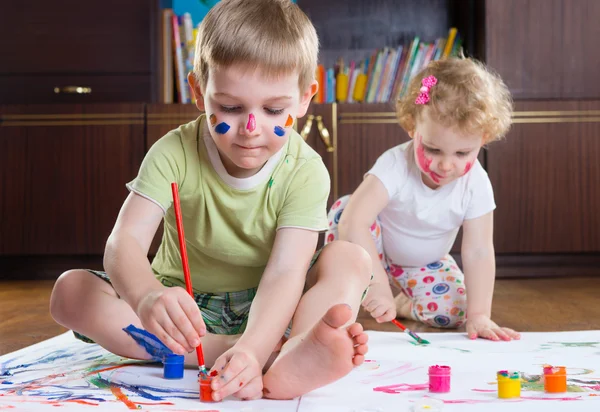 Two cute kids painting