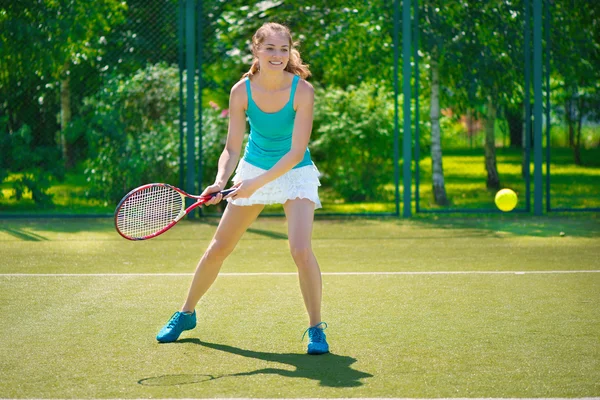 Portrait of young beautiful woman playing tennis