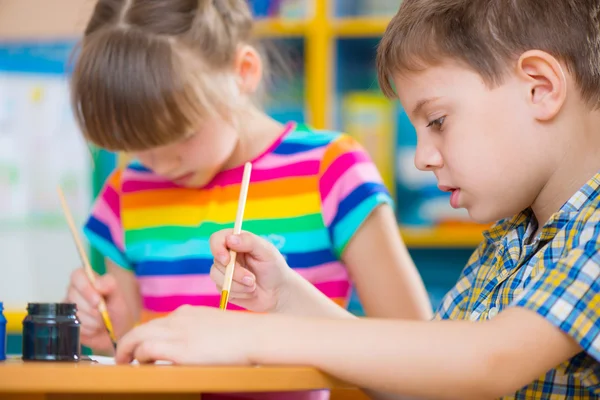 Cute children painting at kindergarten