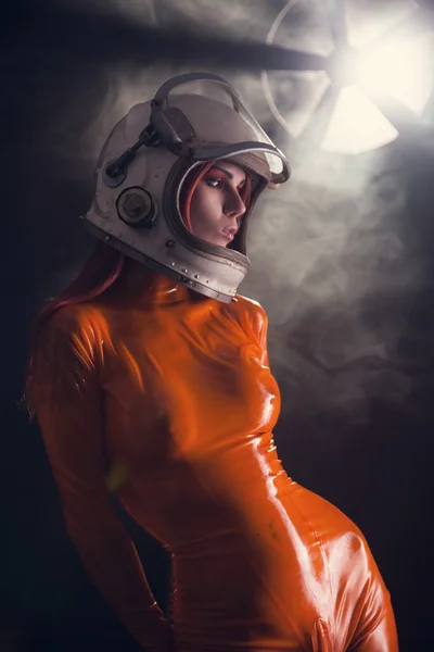 Portrait of sexy girl in orange latex catsuit