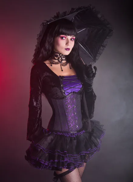 Beautiful girl in purple and black gothic Victorian outfit