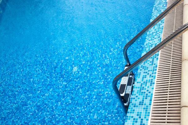 Close-up shot of swimming pool with ladder