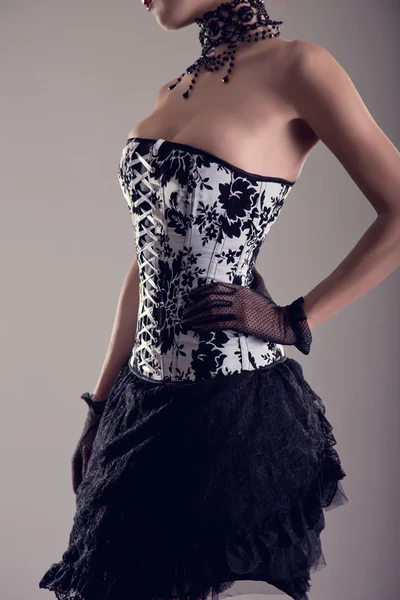 Sensual young woman in black and white corset with floral patter