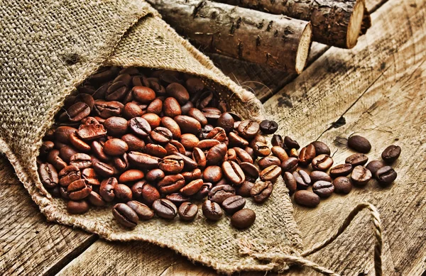 Coffee beans in bag on a old wooden background