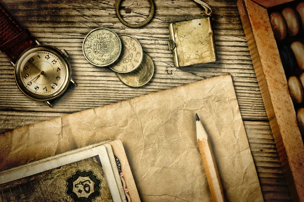 Old notes and coins and abacus on a wooden table