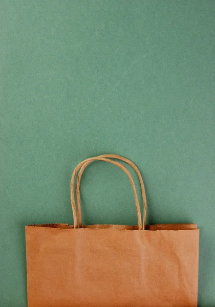 Paper bag on a green background — Stock Photo #25561287