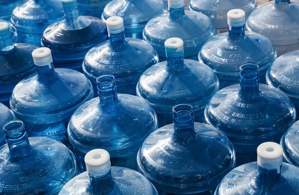 Big empty water bottles in a row