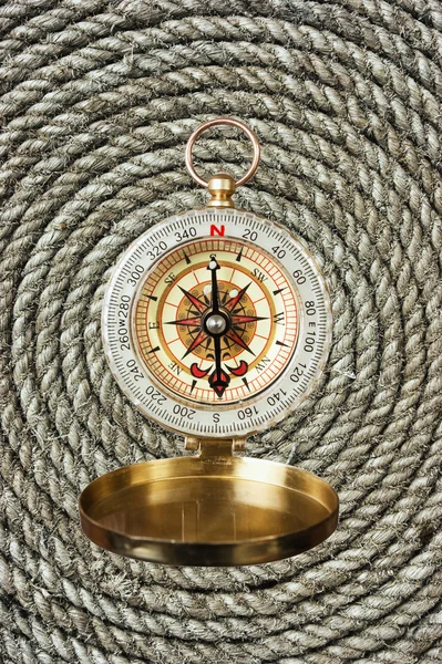 Compass on old twisted rope