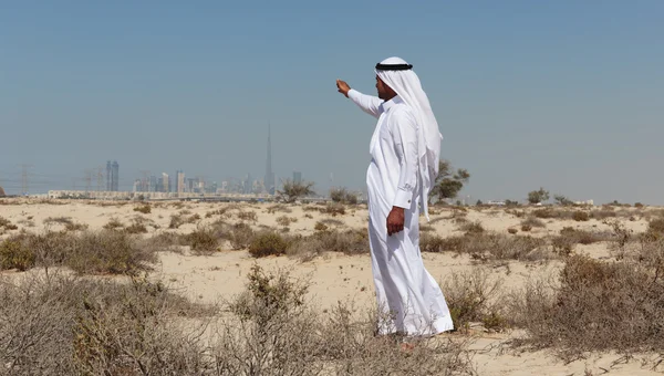 Arab man  stands in the desert