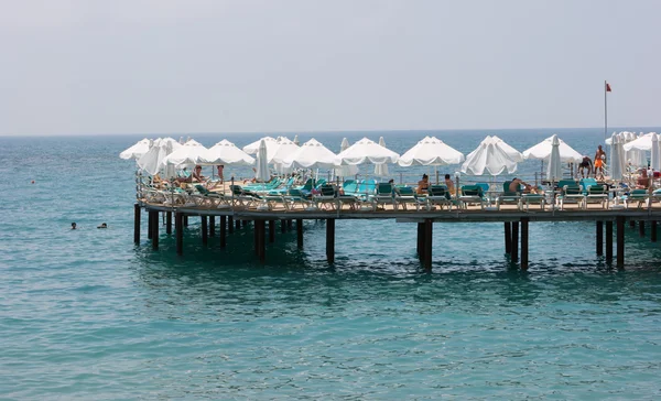 Chaise-longue on the pier at the sea