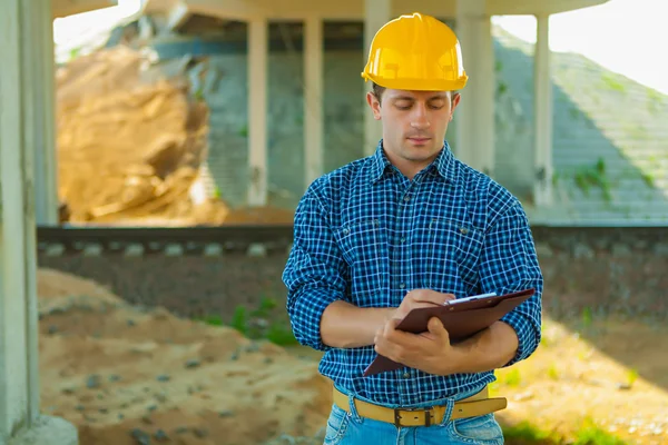 Contractor writing in clipboard