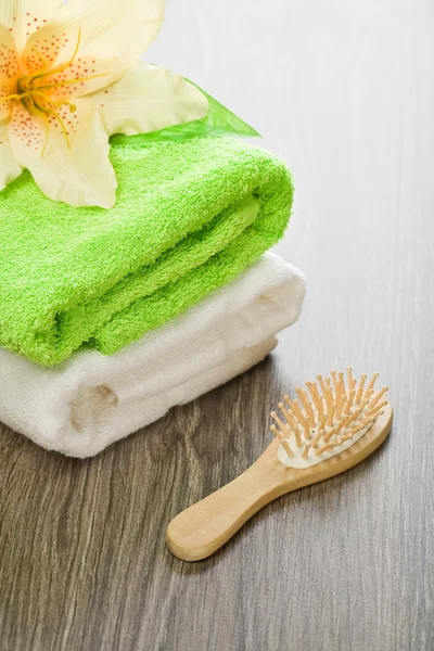 Flower on cotton towels with hairbrush
