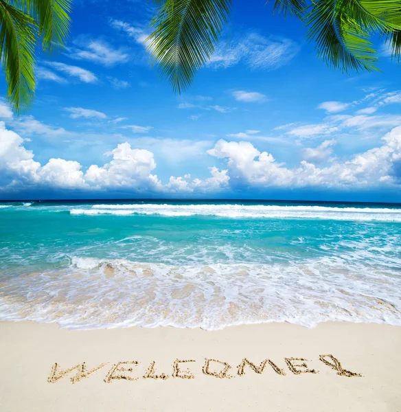 Welcome written in beach