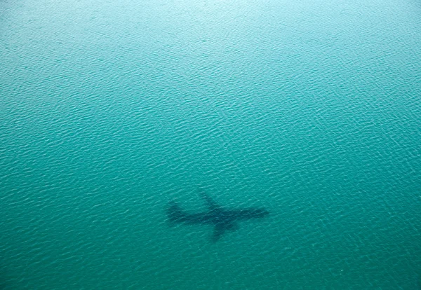 Plane silhouette on water