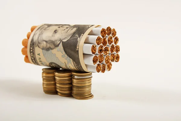 Cigarettes and money on a white background.