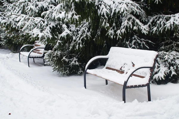 The image of a snow-covered bench