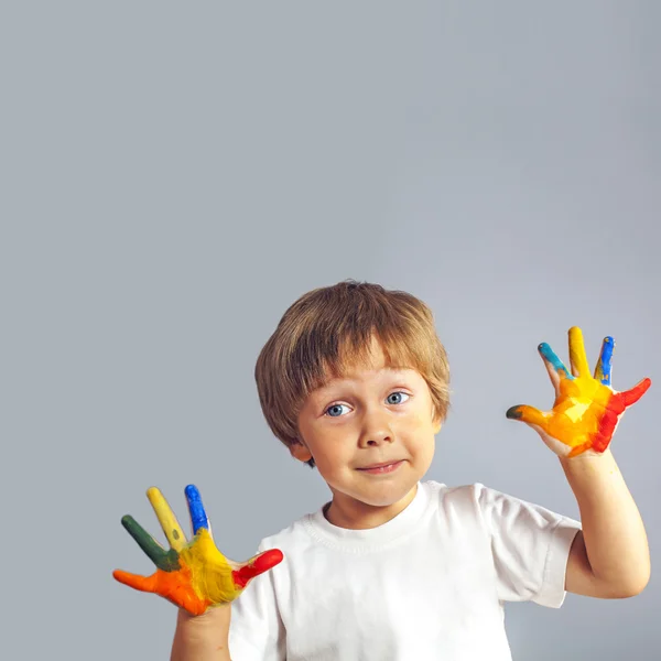 Boy with hands painted in colorful paints