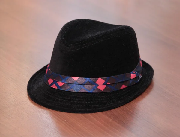 Kid black hat on wooden background