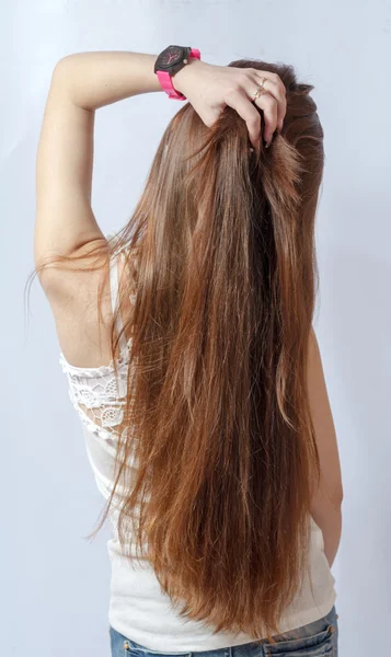 Girl with long fair hair from back