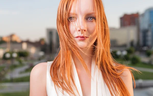 Portrait of freckled young woman cityscape