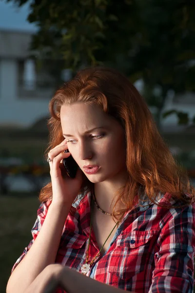 Red haired woman call by cell phone