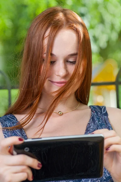 Redhead student  using her tablet