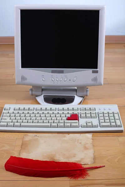 Desktop computer with Antique red pen at old paper