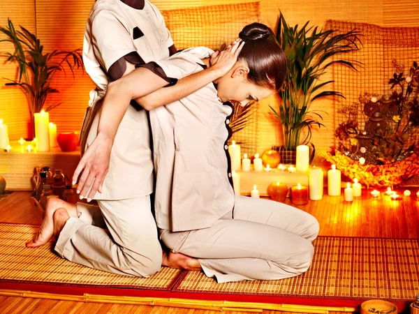 Therapist giving stretching massage to woman.