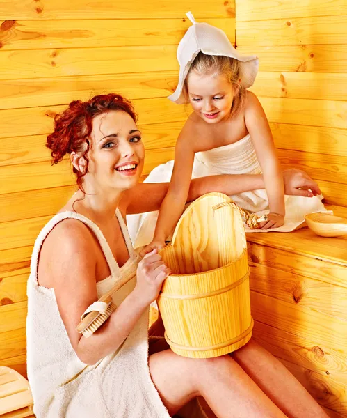 Family with child relaxing at sauna.