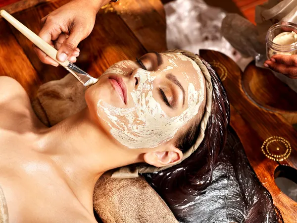 Woman having mask at ayurveda spa.