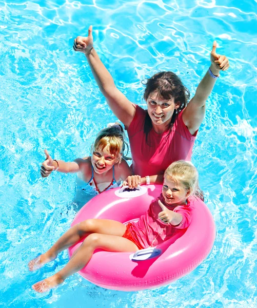 Family in swimming pool.