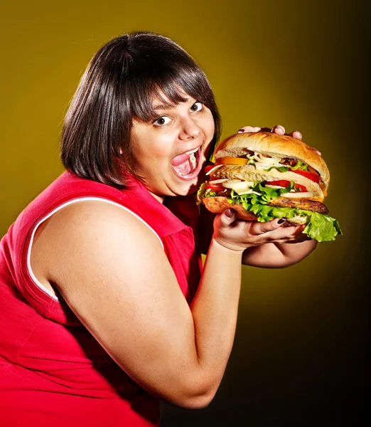 Woman eating hamburger.