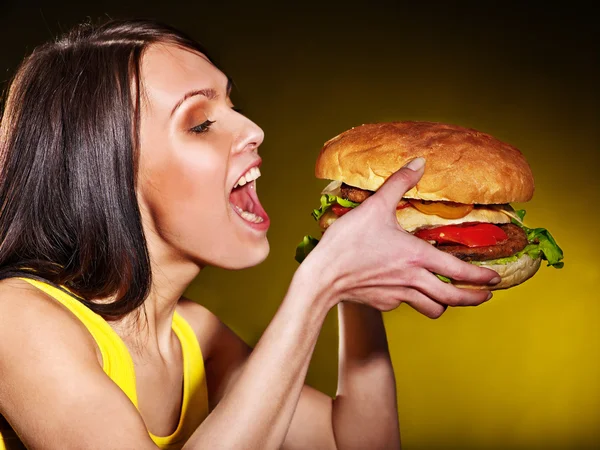 Woman eating hamburger.