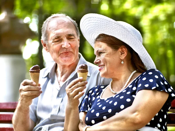 Happy old couple with ice-cream.