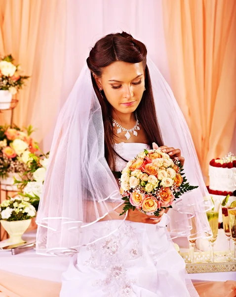 Bride at wedding table.