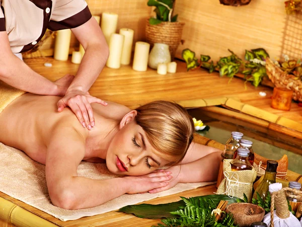 Woman getting stone therapy massage .