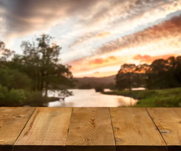 Old wooden table or walkway by lake
