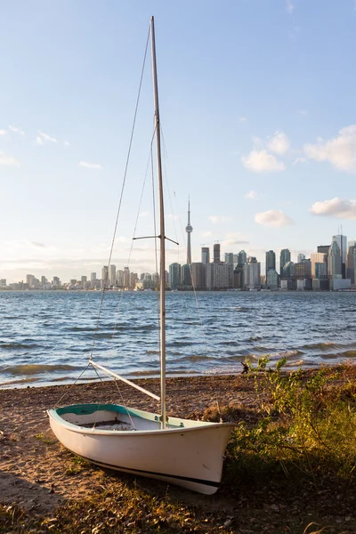 Sailing boat on Toronto Islands with city