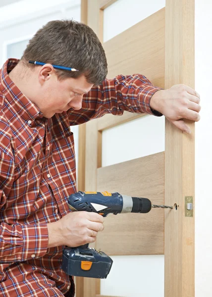 Carpenter at door lock installation