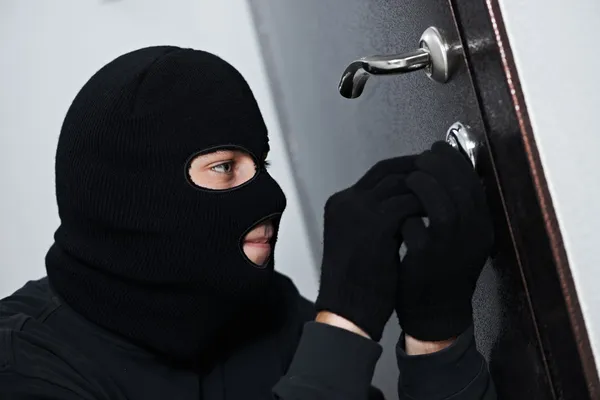 Burglar thief at house breaking