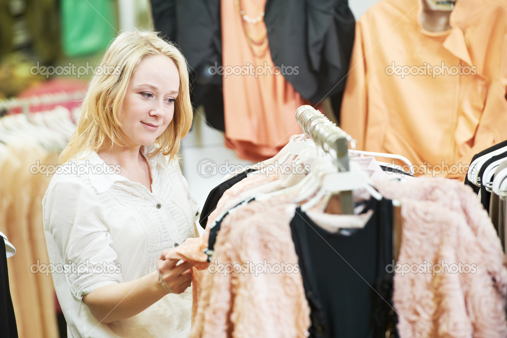 Young woman at clothes shopping store - Stock Image