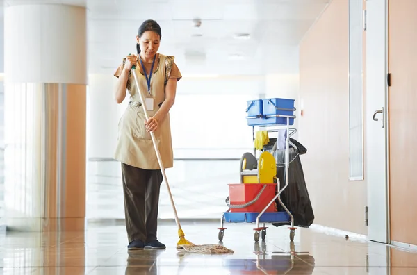 Woman cleaning building hall