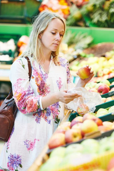 Young woman at food shopping in supermarket