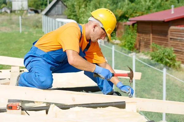 Carpenter works on roof