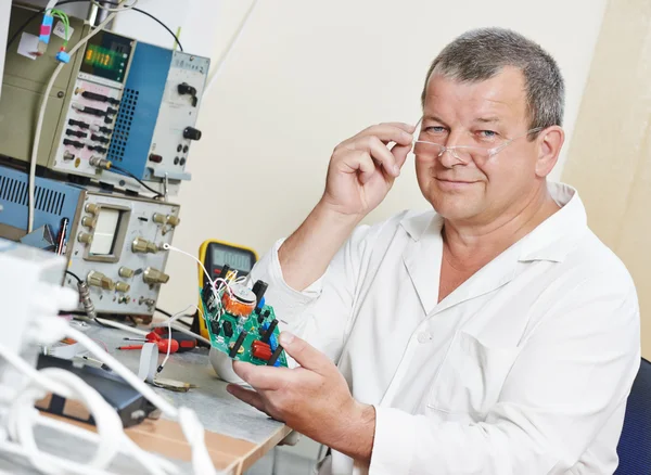 Technician engineer at work with microchip