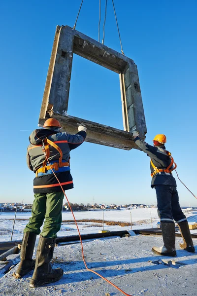 Builder worker installing concrete panel